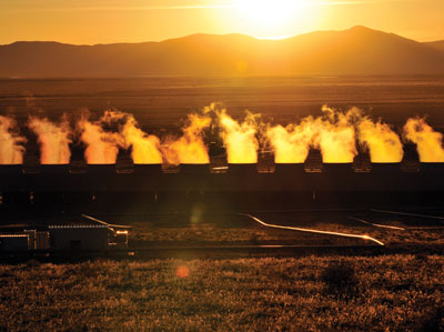 Back-lit steam and sunset at Blue Mountain geothermal plant.
