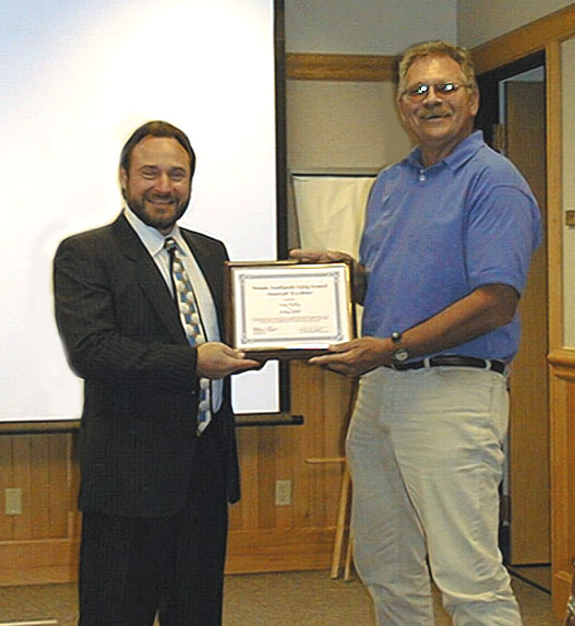 NESC Chairman Ron Lynn presents award to Corey Farley